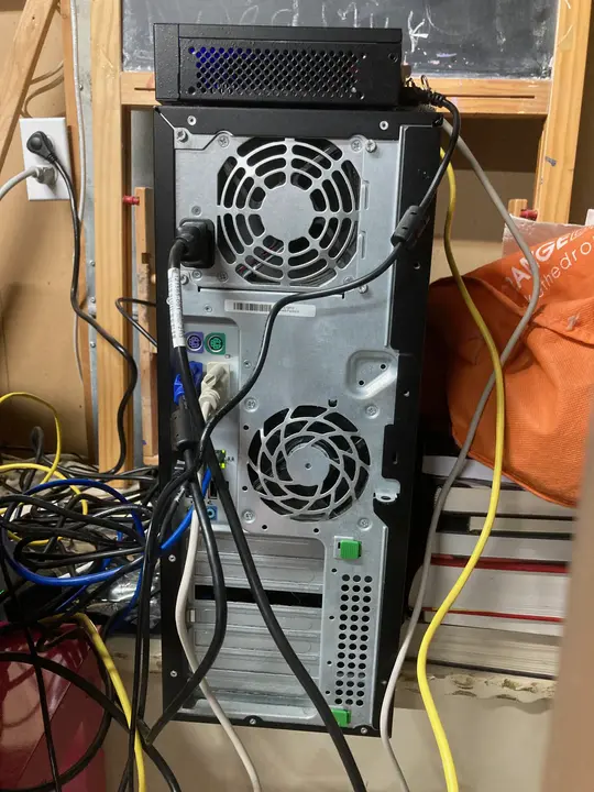 backside of the computer, featuring many ports and cables