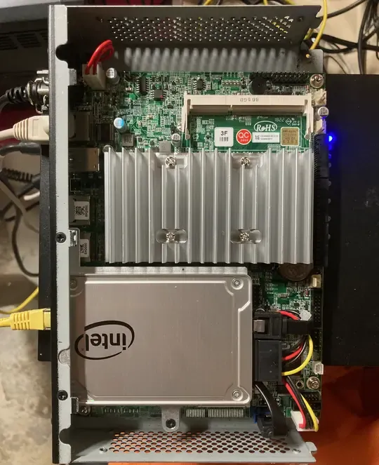 internal hardware of the router showing a heatsink, SSD and motherboard.
